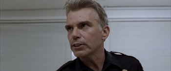 Movie still from “Monster's Ball” (2001), directed by Marc Forster – A person wearing a police uniform; Close Up shot, Low angle