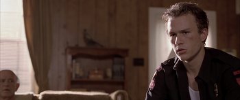 Movie still from “Monster's Ball” (2001), directed by Marc Forster – A person in a living room with a couch; Close Up shot, Over the shoulder angle