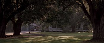 Movie still from “Monster's Ball” (2001), directed by Marc Forster – A large tree in front of a house; Extreme Wide shot, Low angle