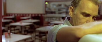 Movie still from “Monster's Ball” (2001), directed by Marc Forster – A person with their ear up in a restaurant; Close Up shot, Low angle