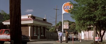 Movie still from “Monster's Ball” (2001), directed by Marc Forster – Two men standing in front of a gas station; Extreme Wide shot, Low angle
