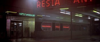 Movie still from “Monster's Ball” (2001), directed by Marc Forster – A neon restaurant sign is lit up at night; Extreme Wide shot, High angle