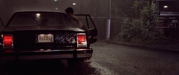 Movie still from “Monster's Ball” (2001), directed by Marc Forster – A man sitting in the back of a truck in the rain; Wide shot, Low angle
