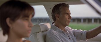 Movie still from “Monster's Ball” (2001), directed by Marc Forster – A man sitting in the back seat of a car; Close Up shot, Over the shoulder angle