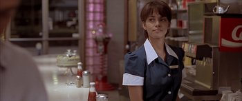 Movie still from “Monster's Ball” (2001), directed by Marc Forster – A woman standing in front of a table with drinks on it; Close Up shot, Over the shoulder angle