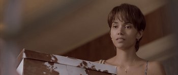 Movie still from “Monster's Ball” (2001), directed by Marc Forster – A woman holding a box in front of her face; Close Up shot, Over the shoulder angle