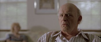 Movie still from “Monster's Ball” (2001), directed by Marc Forster – An old man with a bald head is looking at the camera; Close Up shot, Over the shoulder angle