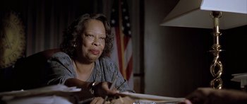 Movie still from “Monster's Ball” (2001), directed by Marc Forster – An older woman sitting in front of an american flag; Close Up shot, Low angle