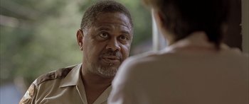 Movie still from “Monster's Ball” (2001), directed by Marc Forster – An older black man talking to a younger white man; Close Up shot, Over the shoulder angle