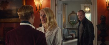 Movie still from “Mortdecai” (2015), directed by David Koepp – A woman standing next to a man in front of a mirror; Medium shot, Over the shoulder angle