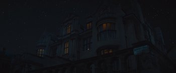 Movie still from “Mortdecai” (2015), directed by David Koepp – A night time picture of a building with a lot of windows lit up; Extreme Wide shot, Low angle