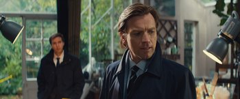 Movie still from “Mortdecai” (2015), directed by David Koepp – A person wearing a suit and tie; Close Up shot, Over the shoulder angle