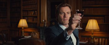 Movie still from “Mortdecai” (2015), directed by David Koepp – A man that is taking a picture with a cell phone; Close Up shot, Low angle