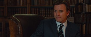 Movie still from “Mortdecai” (2015), directed by David Koepp – A person wearing a suit and tie; Close Up shot, Over the shoulder angle