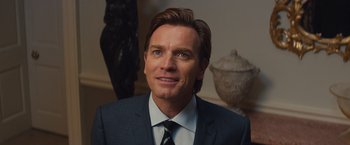 Movie still from “Mortdecai” (2015), directed by David Koepp – A person wearing a suit and tie; Close Up shot, Over the shoulder angle