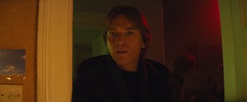 Movie still from “Mortdecai” (2015), directed by David Koepp – A man is looking into a mirror in a dark room; Close Up shot, Low angle