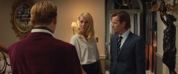 Movie still from “Mortdecai” (2015), directed by David Koepp – Two men and a woman standing in front of each other; Medium shot, Over the shoulder angle