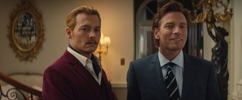 Movie still from “Mortdecai” (2015), directed by David Koepp – Two men standing next to each other in front of a wall; Close Up shot, Low angle