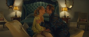 Movie still from “Mortdecai” (2015), directed by David Koepp – A man and a woman kissing in a bedroom; Medium shot, Low angle