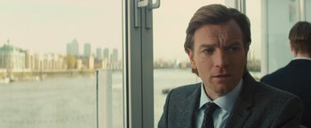 Movie still from “Mortdecai” (2015), directed by David Koepp – A person wearing a suit and tie; Close Up shot, Over the shoulder angle