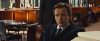 Movie still from “Mortdecai” (2015), directed by David Koepp – A person wearing a suit and tie; Close Up shot, Over the shoulder angle