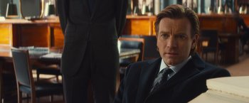 Movie still from “Mortdecai” (2015), directed by David Koepp – A person wearing a suit and tie; Close Up shot, Over the shoulder angle
