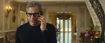Movie still from “Mortdecai” (2015), directed by David Koepp – A man in a black shirt talking on a cell phone; Close Up shot, Low angle
