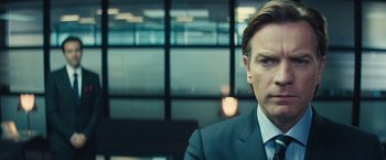 Movie still from “Mortdecai” (2015), directed by David Koepp – A person wearing a suit and tie; Close Up shot, Over the shoulder angle