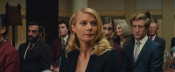 Movie still from “Mortdecai” (2015), directed by David Koepp – A woman with long blonde hair wearing a black jacket; Close Up shot, Over the shoulder angle