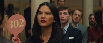 Movie still from “Mortdecai” (2015), directed by David Koepp – A woman with red lipstick and a man in a black suit; Close Up shot, Over the shoulder angle