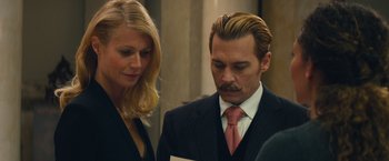 Movie still from “Mortdecai” (2015), directed by David Koepp – A man and a woman looking at a piece of paper; Close Up shot, Over the shoulder angle