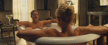 Movie still from “Mortdecai” (2015), directed by David Koepp – A man and a woman in a bath tub in front of a mirror; Medium shot, Low angle
