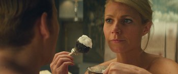 Movie still from “Mortdecai” (2015), directed by David Koepp – A woman is holding a brush in front of a mirror; Close Up shot, Over the shoulder angle