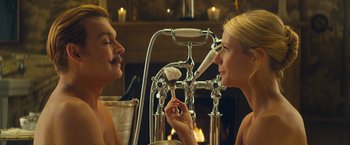 Movie still from “Mortdecai” (2015), directed by David Koepp – A man and a woman are looking at each other in front of a mirror; Medium shot, Over the shoulder angle