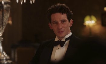 Movie still from “Mothering Sunday” (2021), directed by Eva Husson – A man in a tuxedo is posing for a picture; Close Up shot, Over the shoulder angle