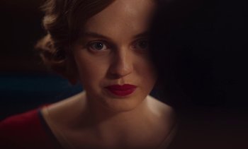 Movie still from “Mothering Sunday” (2021), directed by Eva Husson – A person wearing a red lipstick; Close Up shot, Over the shoulder angle