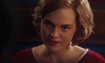 Movie still from “Mothering Sunday” (2021), directed by Eva Husson – A person with short hair; Close Up shot, Over the shoulder angle