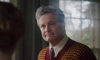 Movie still from “Mothering Sunday” (2021), directed by Eva Husson – A person wearing a sweater; Close Up shot, Over the shoulder angle