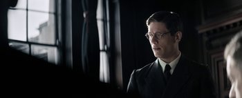 Movie still from “Mr. Jones” (2019), directed by Agnieszka Holland – A man in a suit and tie looking off into the distance; Close Up shot, Low angle