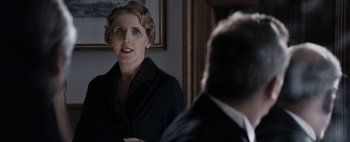 Movie still from “Mr. Jones” (2019), directed by Agnieszka Holland – An older woman standing in front of a man in a suit; Close Up shot, Over the shoulder angle