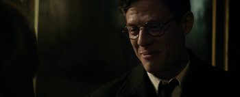 Movie still from “Mr. Jones” (2019), directed by Agnieszka Holland – A person wearing glasses and a suit; Close Up shot, Over the shoulder angle