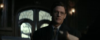 Movie still from “Mr. Jones” (2019), directed by Agnieszka Holland – A man wearing glasses and a suit and tie; Close Up shot, Low angle