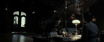 Movie still from “Mr. Jones” (2019), directed by Agnieszka Holland – A man sitting at a table in front of a laptop computer; Medium shot, Low angle