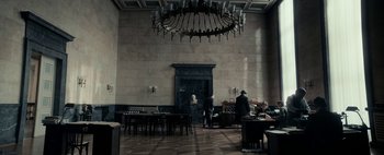 Movie still from “Mr. Jones” (2019), directed by Agnieszka Holland – A room filled with furniture and a chandelier; Wide shot, High angle