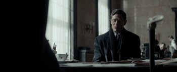Movie still from “Mr. Jones” (2019), directed by Agnieszka Holland – A man sitting at a table in front of a window; Medium shot, Over the shoulder angle