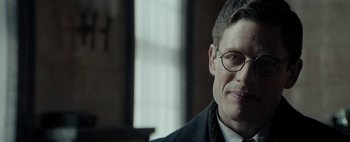 Movie still from “Mr. Jones” (2019), directed by Agnieszka Holland – A person wearing a suit and glasses; Close Up shot, Low angle