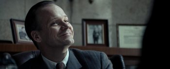 Movie still from “Mr. Jones” (2019), directed by Agnieszka Holland – A man in a suit and tie looking up at the sky; Close Up shot, Over the shoulder angle