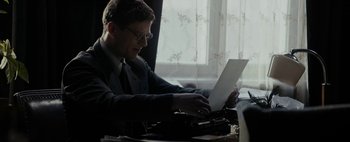 Movie still from “Mr. Jones” (2019), directed by Agnieszka Holland – A man sitting at a desk typing on a typewriter; Medium shot, Low angle
