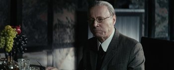 Movie still from “Mr. Jones” (2019), directed by Agnieszka Holland – An older man wearing a suit and tie; Close Up shot, Low angle
