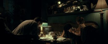 Movie still from “Mr. Jones” (2019), directed by Agnieszka Holland – A man and a woman sitting at a dinner table; Medium shot, High angle